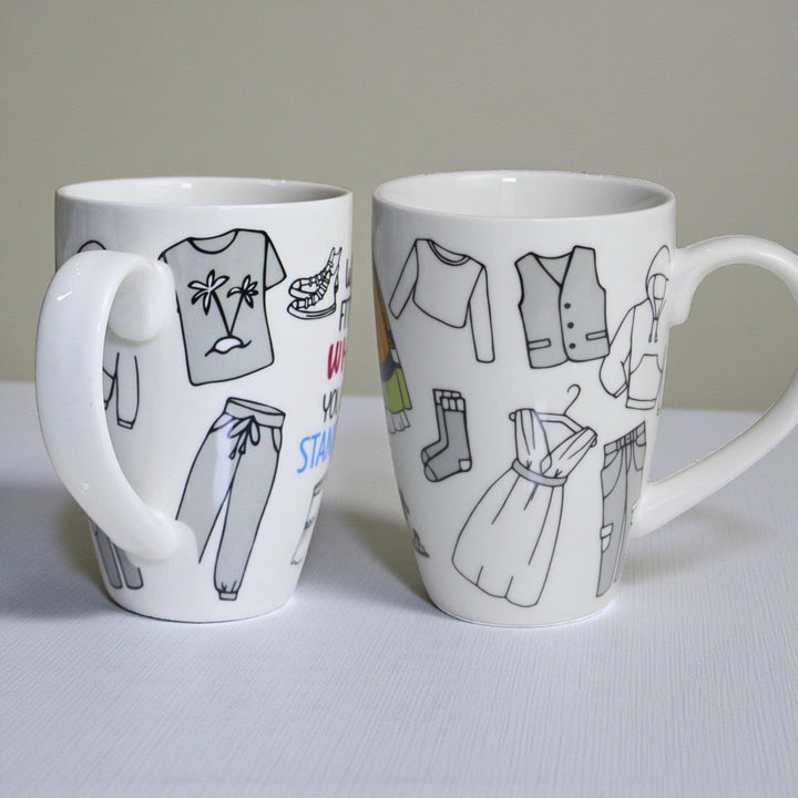 Images of one white ceramic mug with  wraparound black line drawings of clothing items.