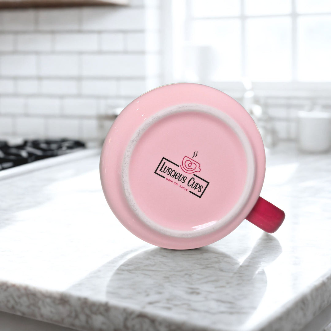 Pink mug with a visible brand logo of Luscious Cups on a kitchen counter
