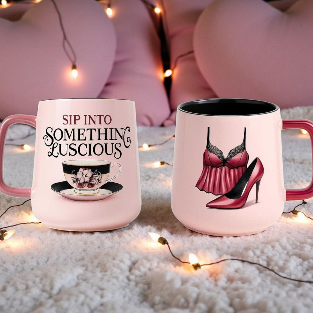 Front and back of a ceramic pink mug with black interior with a tea cup and text on the front and lingerie and high heel on the back