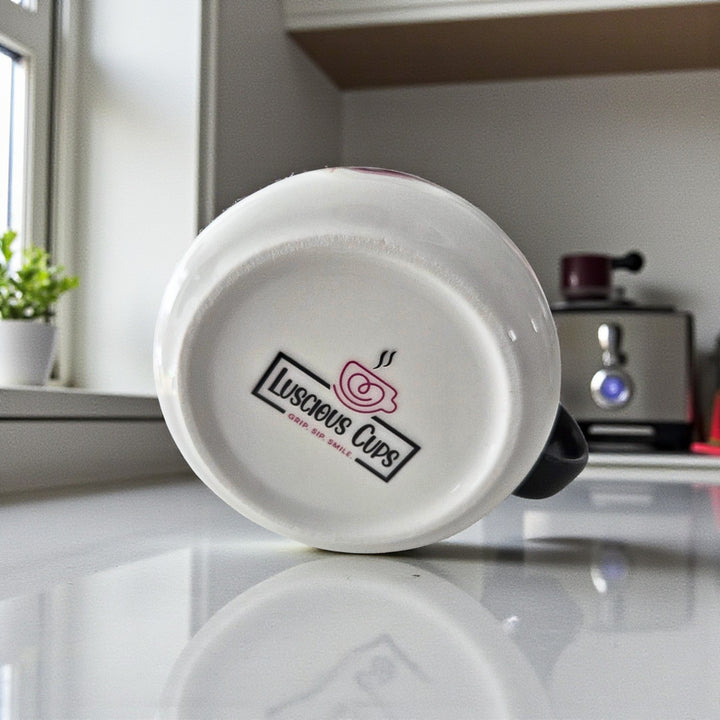 White ceramic mug with 'Luscious Cups' logo on a kitchen counter