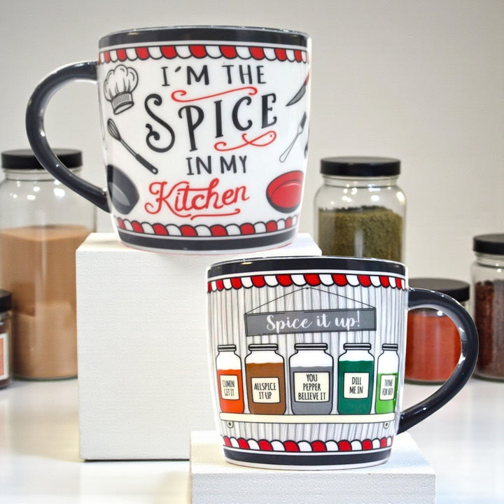 Front and back of a kitchen-themed ceramic mug with wraparound design of text on the front and  illustrated spice jars on the back.